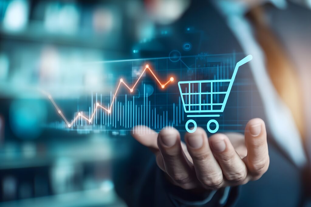 Close-up de uma mão masculina vestindo um terno, estendida para segurar e apoiar dados holográficos flutuantes, incluindo um gráfico de linha ascendente e um carrinho de compras digital azul brilhante.